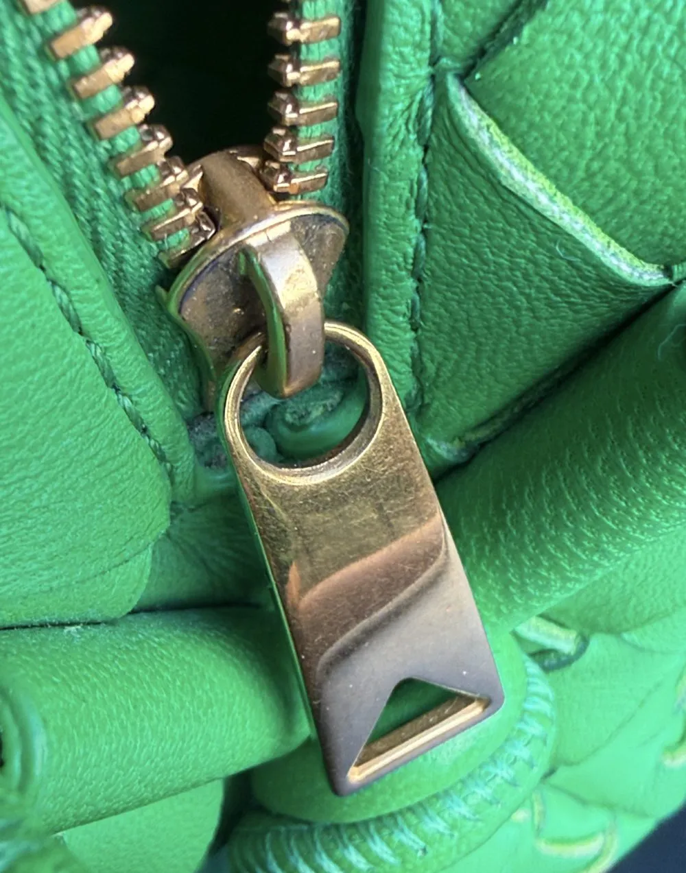Zipper pull on a green Bottega Veneta bag inside the capture frame
